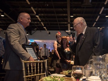 Charles Williams (R) is given an award as he is inducted into the 2016 Business Hall of Fame at the SABEX awards at Prairieland Park in Saskatoon, May 19, 2016.