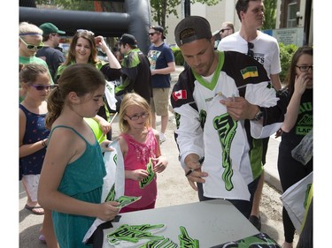 The Saskatchewan Rush of the National Lacrosse League held a noon-hour rally on 21st Street East in Saskatoon, May 20, 2016, in a lead up to their weekend battle with the Calgary Roughnecks. Food trucks and other festivities were featured for fans, as well as an attendance by a number of players. Adrian Sorichetti signs team items for fans.