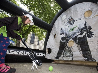 The Saskatchewan Rush of the National Lacrosse League held a noon-hour rally on 21st Street East in Saskatoon, May 20, 2016, in a lead up to their weekend battle with the Calgary Roughnecks. Food trucks and other festivities were featured for fans, as well as an attendance by a number of players. Daryna Schemenager tries to score in shooting gallery.