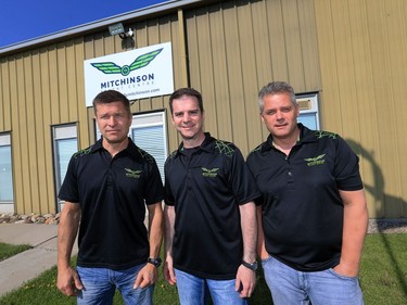 L-R: Mitchinson Flying Service owners Jim Guenther, Dan Glass and Dale Tiedeman at the business, May 27, 2016.  Mitchinson is celebrating its 70th anniversary.