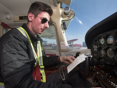 Mitchinson Flying Service pilot Luke Matchett does a pre-flight check before taking off, May 27, 2016. Mitchinson is celebrating its 70th anniversary.