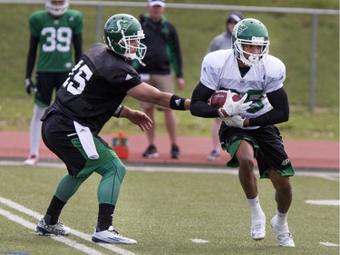 Quarterback B.J. Coleman hands off to wide receiver Marquez Clark during Saskatchewan Roughriders training camp at Griffiths Stadium, May 30, 2016.