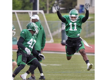 Defensive back Ed Gainey (R) leaping in rush drill during Saskatchewan Roughriders training camp at Griffiths Stadium, May 30, 2016.