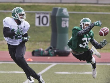 Wide receiver John Chiles has the ball tipped away by linebacker Marte Sears during a pass drill at Saskatchewan Roughriders training camp at Griffiths Stadium, May 30, 2016.