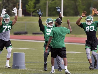 L-R: Defensive linemen Dillon Grondin, Tim Agbaje and Kalonji Kashama during rush drill at Saskatchewan Roughriders training camp at Griffiths Stadium, May 30, 2016.