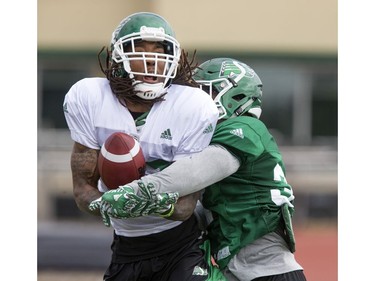 Wide receiver Naaman Roosevelt is just stopped front the catch by defensive back Tyree Hollins during Saskatchewan Roughriders training camp at Griffiths Stadium, May 30, 2016.