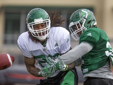 Wide receiver Naaman Roosevelt is just stopped front the catch by defensive back Tyree Hollins during Saskatchewan Roughriders training camp at Griffiths Stadium, May 30, 2016.