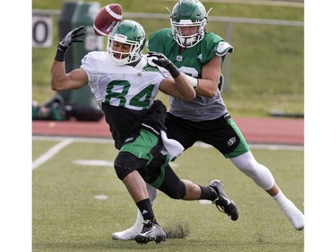 Wide receiver Seydou Haidara is grabbed away from the ball on a pass play by linebacker Dillon Grondon during Saskatchewan Roughriders training camp at Griffiths Stadium, May 30, 2016.