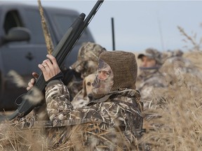 American hunter Keith Hill cradles his shotgun in a field near Delisle in October 2013.