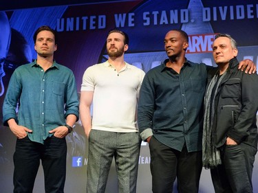 L-R: Actors Sebastian Stan, Chris Evans, Anthony Mackie and director Joe Russo pose for a photo call after a press conference at Marina Bay Sands in Singapore on April 21, 2016, during a press tour to promote "Captain America: Civil War."