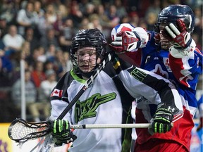Toronto Rock captain Colin Doyle comes over the shoulder of Robert Church of the Saskatchewan Rush in National Lacrosse League action.