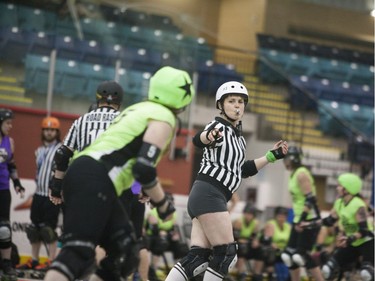 Jessica Albad (L) receives a call from the referee during the Attack of the 8 Wheeled Woman Roller Derby Tournament in Warman, May 14, 2016.