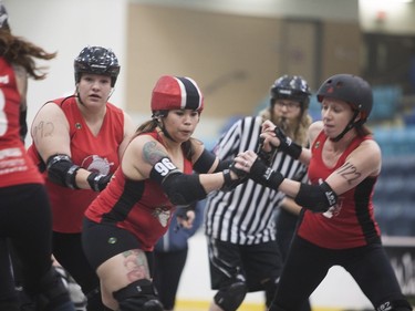 Tidbit Knawty, #96 (Centre left) of the Saskatoon Mindfox acts as the teams Pivot who leads the pack during the Attack of the 8 Wheeled Woman Roller Derby Tournament  in Warman, Saskatchewan, May 14, 2016.