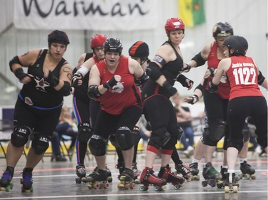 Unicorn Thunder (Centre left) of the Saskatoon Mindfox blocks the other team's jammer during the Attack of the 8 Wheeled Woman Roller Derby Tournament in Warman, May 14, 2016.