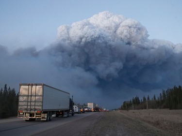 Drivers wait for clearance to take firefighting supplies into town on May 5, 2016 outside of Fort McMurray, Alberta. Wildfires, which are still burning out of control, have forced the evacuation of more than 80,000 residents from the town.