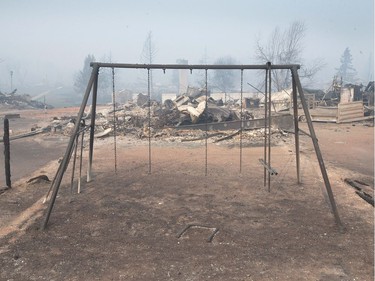 A swing set with the swings burned away sits in a residential neighbourhood destroyed by a wildfire on May 6, 2016 in Fort McMurray, Alberta. Wildfires, which are still burning out of control, have forced the evacuation of more than 80,000 residents from the town.