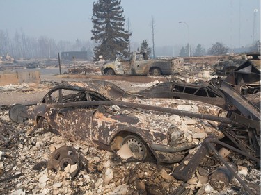 The remains of a classic Triumph GT6 sit in a residential neighbourhood destroyed by a wildfire on May 6, 2016 in Fort McMurray, Alberta. Wildfires, which are still burning out of control, have forced the evacuation of more than 80,000 residents from the town.