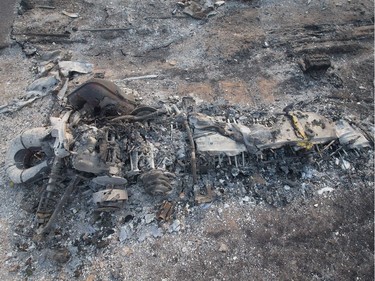 The remains of a charred snowmobile sit in a residential neighbourhood destroyed by a wildfire on May 6, 2016 in Fort McMurray, Alberta. Wildfires, which are still burning out of control, have forced the evacuation of more than 80,000 residents from the town.