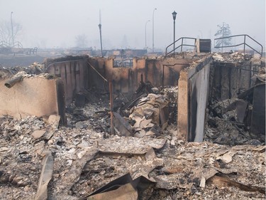 Home foundations are all that remain in a residential neighbourhood destroyed by a wildfire on May 6, 2016 in Fort McMurray, Alberta. Wildfires, which are still burning out of control, have forced the evacuation of more than 80,000 residents from the town.