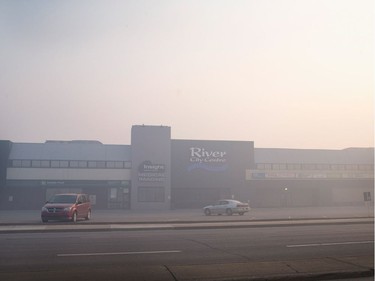 Smoke from wildfires fill the morning air in front of a shopping centre on May 6, 2016 in Fort McMurray, Alberta. Wildfires, which are still burning out of control, have forced the evacuation of more than 80,000 residents from the town.