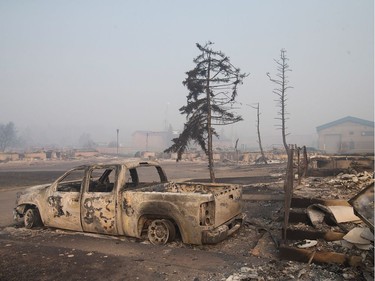 Home foundations and shells of vehicles are nearly all that remain in a residential neighbourhood destroyed by a wildfire on May 6, 2016 in Fort McMurray, Alberta. Wildfires, which are still burning out of control, have forced the evacuation of more than 80,000 residents from the town.