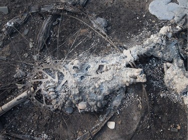 The remains of a charred bicycle sits in a residential neighbourhood on May 6, 2016 in Fort McMurray, Alberta. Wildfires, which are still burning out of control, have forced the evacuation of more than 80,000 residents from the town.