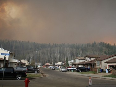 Wildfires swarm over the subdivision of Grayling Terrace as viewed from Grayling Crescent in Fort McMurray, Alberta, May 3, 2016. The subdivision had been placed under a mandatory evacuation Tuesday afternoon.