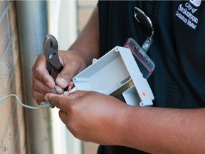 A city of Saskatoon technician demonstrates the installation of one of the new Advanced Metering Infrastructure modules, which the city will be installing in residences on a going-forward basis. The modules will allow the city to track home water usage using radio frequencies.