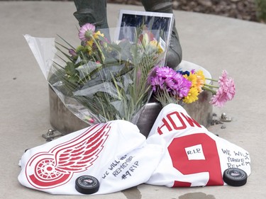 A collection of flowers, pucks and jerseys at the Gordie Howe statue outside of Sasktel Centre in Saskatoon, June 10, 2016. Howe passed away today at the age of 88.