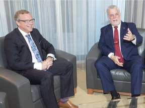Saskatchewan Premier Brad Wall, left, and Quebec Premier Philippe Couillard chat during the photo op before their meeting Thursday, June 16, 2016 in Montreal.