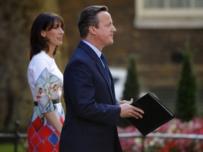 British Prime Minister David Cameron flanked by his wife Samantha speaks to reporters after Britons voted narrowly to leave the European Union. He plans to quit as PM in October.