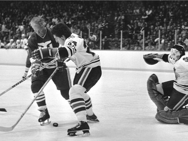 Chicago Blackhawks #24 Doug Wilson defends against Hartford Whalers Gordie Howe during action, October 15, 1979 in Chicago.