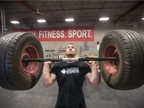 Strongman QuInton Falk demonstrates a few of the events at the upcoming Strongman competition at Synergy Strength Crossfit.