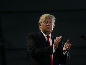 Republican presidential candidate Donald Trump applauds during a rally, Thursday, June 2, 2016, in San Jose, Calif.