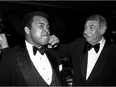 FILE - In this April 13, 1981, file photo, sportscaster Howard Cosell, right, is pictured laying one on the chin of former world heavyweight boxing champ Muhammad Ali during a dinner in New York. Ali, the magnificent heavyweight champion whose fast fists and irrepressible personality transcended sports and captivated the world, has died according to a statement released by his family Friday, June 3, 2016. He was 74.