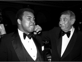 FILE - In this April 13, 1981, file photo, sportscaster Howard Cosell, right, is pictured laying one on the chin of former world heavyweight boxing champ Muhammad Ali during a dinner in New York. Ali, the magnificent heavyweight champion whose fast fists and irrepressible personality transcended sports and captivated the world, has died according to a statement released by his family Friday, June 3, 2016. He was 74.