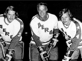 In this Aug. 3, 1973, file photo, former Detroit Red Wings great Gordie Howe, center, is flanked by sons Marty, left, and Mark as they try their new Houston Aeros uniforms in St. Clair Shores, Mich. Gordie Howe, the hockey great who set scoring records that stood for decades, died Friday, June 10, 2016. He was 88.