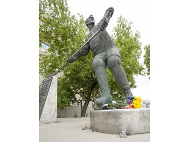 Flowers have been left at the Gordie Howe statue outside of Sasktel Centre in Saskatoon, June 10, 2016. Howe passed away today at the age of 88.