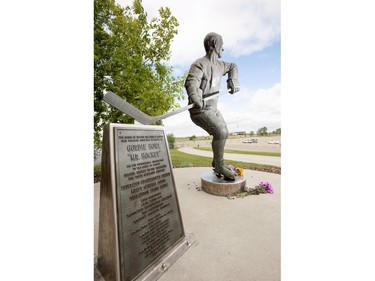 Flowers have been left at the Gordie Howe statue outside of Sasktel Centre in Saskatoon, June 10, 2016. Howe passed away today at the age of 88.