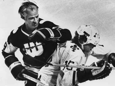 Fifty-year-old Gordie Howe of the New England Whalers delivers one of his well-known elbows to the head of Quebec Nordiques forward Curt Brackenbury, Dec. 17, 1978.