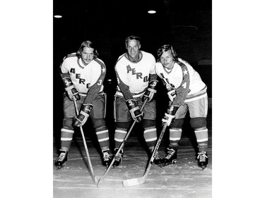 Former Detroit Red Wings great Gordie Howe (C) is flanked by sons Marty (L) and Mark as they try their new Houston Aeros uniforms in St. Clair Shores, Michigan, August 3, 1973.