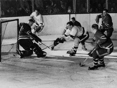Gordie Howe of the Detroit Red Wings, puts a puck past Johnny Bower of the New York Rangers for his 215th goal November 11, 1953, during National Hockey League action in New York.
