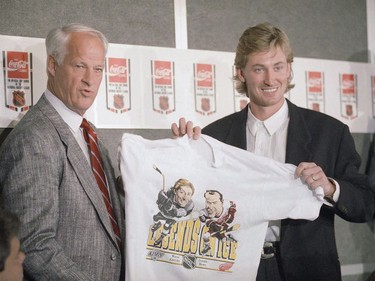 Hockey superstars Wayne Gretzky (R) and Gordie Howe hold up a T-shirt featuring them as "Legends on Ice" during a news conference at the Forum in Inglewood, California, October. 11, 1989.