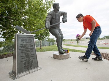 Matt Adamowski lays flowers at the Gordie Howe statue outside of Sasktel Centre in Saskatoon, June 10, 2016. Howe passed away today at the age of 88.