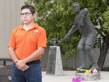 Matt Adamowski stands for a photograph after he put down flowers at the Gordie Howe statue outside of Sasktel Centre in Saskatoon, June 10, 2016. Howe passed away today at the age of 88.