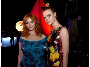 Actors Christina Hendricks (L) and Elle Fanning pose at the after party for the premiere of Amazon's "The Neon Demon" at the Hollywood Forever Cemetery on June 14, 2016 in Los Angeles, California.