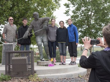 L-R: Sad Palmister, Daniel Lashyn, Marie Lashyn, Kate Lashyn and Lauren Lashyn stand for a photograph with the Gordie Howe statue outside of Sasktel Centre in Saskatoon, June 10, 2016. Howe passed away today at the age of 88.