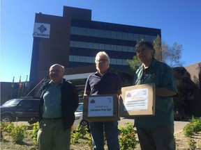 Sandy Ervin, from left, Gary Smith and Don Kossick of Canadians for Tax Fairness attempt to deliver a petition Wednesday in Saskatoon urging Cameco Corp. to repay $2.1 billion they say it owes the Canada Revenue Agency.