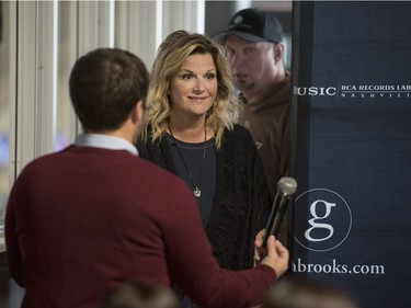 Garth Brooks, right, and Trisha Yearwood walk to the stage prior to speaking to the media at SaskTel Centre on Thursday, June 9, 2016.