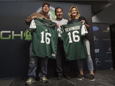 University of Saskatchewan Chancellor Blaine Favel gives  Huskies jerseys to Garth Brooks, left, and Trisha Yearwood during a media event at Sasktel Centre on Thursday, June 9, 2016.